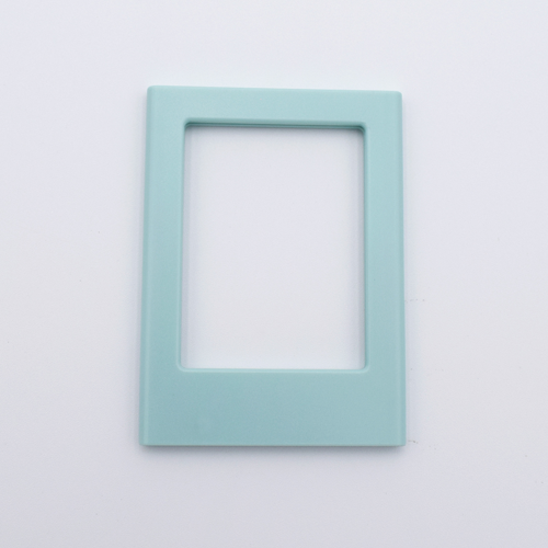 DIY Decoden customizable sea foam green Polaroid loader frames with frosting-inspired glue, decorative sprinkles, charms, and magnets for personalizing your photos.