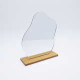 DIY Decoden customizable cloud-shaped acrylic mirror with frosting-inspired glues, decorative sprinkles, and charms, complete with a wooden stand for your desk or vanity.