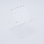 DIY Decoden customizable acrylic phone stand with frosting-inspired glue, decorative sprinkles, and charms for personalizing your phone setup.