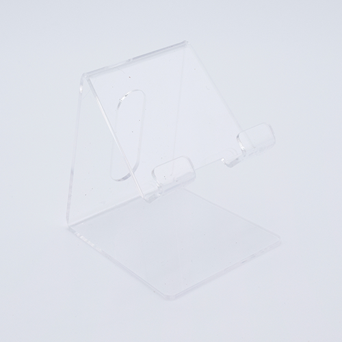 DIY Decoden customizable acrylic phone stand with frosting-inspired glue, decorative sprinkles, and charms for personalizing your phone setup.